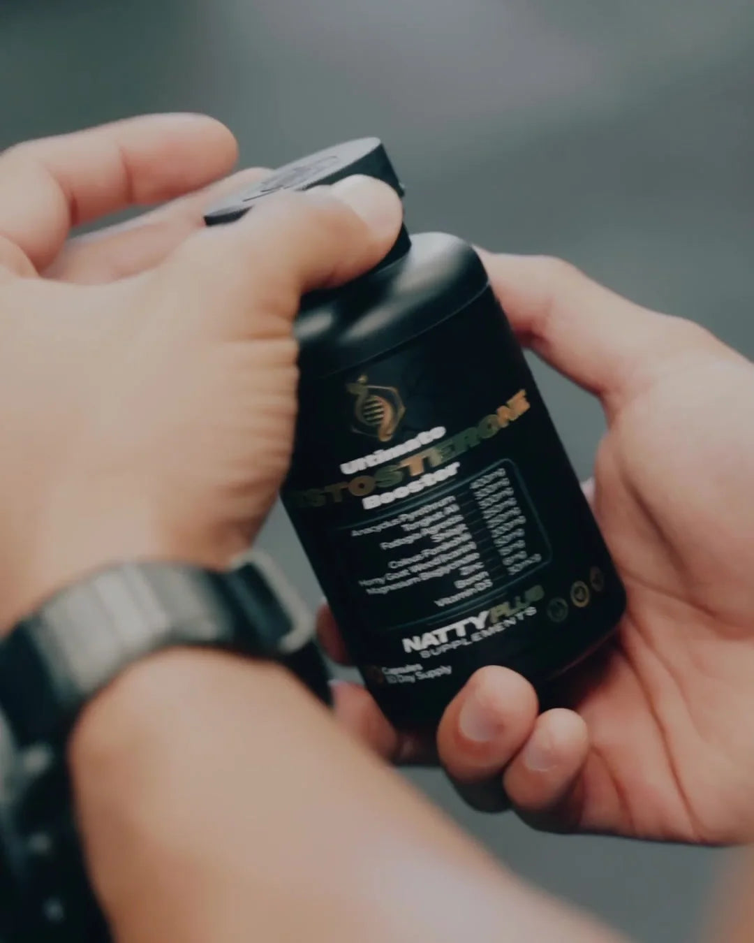 Gabe opening a bottle of the Ultimate Testosterone Booster