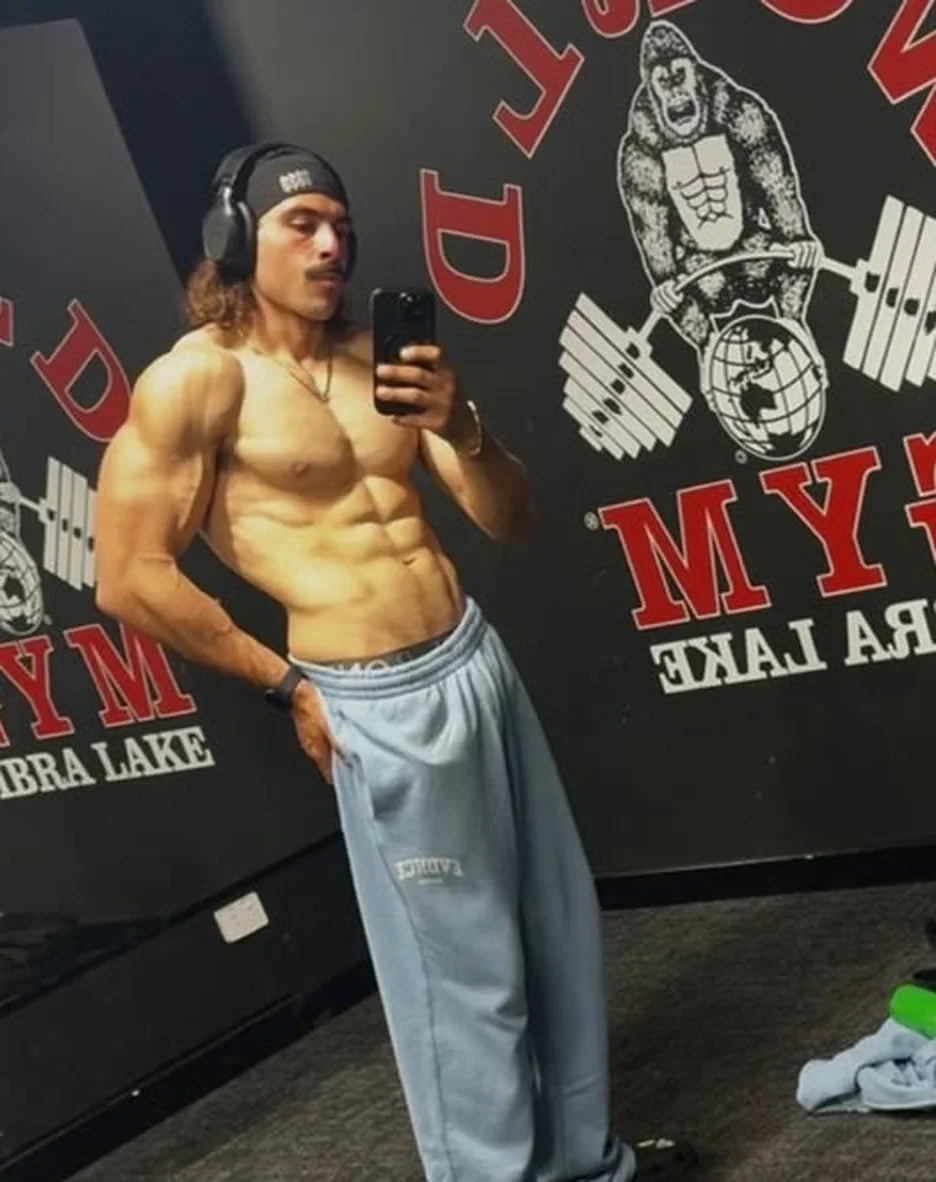 Rambo taking a shirtless mirror selfie at World Gym